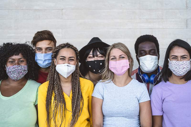 Group of youth standing with masks on. 