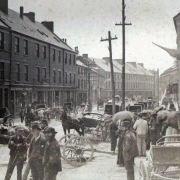 Photo #: 04-21-022  Water Street looking west from Market Square, the hub of as people going about their daily business.  Some of the businesses shown on the south side of Water Street include William Frew, James Baird and Sidney Wood.  Dated 1880s
