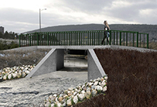 Image is a rendering of a bridge over a river near Long Pond.