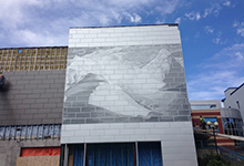 artwork titled Aftermath (cracking up), image of iceberg, being installed on Convention Centre 