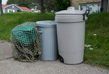 Garbage bags covered with net and in garbage cans
