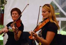 Two musicians playing violins
