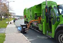 Automated Garbage Truck picking up a cart