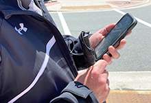 Image of person using BlindSquare app on a mobile phone