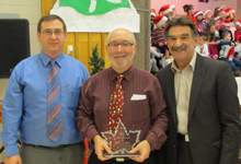 Crossing Guard Wilf Hunt (middle) receives Canada's Favourite Crossing Guard Award