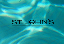 the City of St. John's logo on a background of swimming pool water with sun reflected in the water