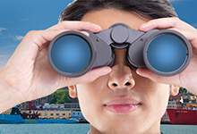 foreground of a close up of a woman looking through binoculars facing forward with St. John's harbourfront in the background