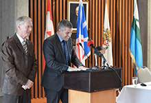 Mayor of St. John's Dennis O'Keefe and Mayor of Happy Valley-Goose Bay Jamie Snook in good spirits while signing a Letter of Intent