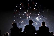 Image of three people watching fireworks