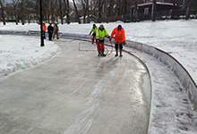 City staff using sprayers to make ice at The Loop, the outdoor skating surface