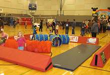 Young children playing in a gym for National Child Day