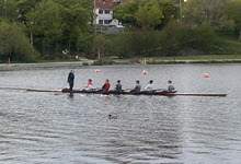 fixed-seat boat with a team practicing rowing on Quidi Vidi Lake