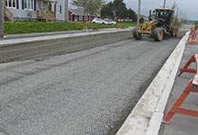 Photo of tractor paving the road
