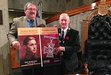 Councillor Sandy Hickman and Mayor Dennis O'Keefe display street banners with images of Victoria Cross recipients