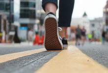 image of a person walking on the yellow line during the Downtown Pedestrian Mall