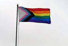 Image of a pride flag on a flag pole.