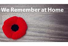 image of a red poppy with text that reads 'we remember at home'