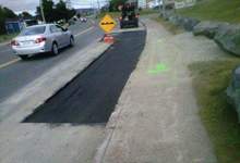 Section of road cut out to be repaired.
