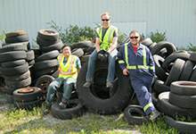 2015 summer litter crew sitting on discarded vehicle tires
